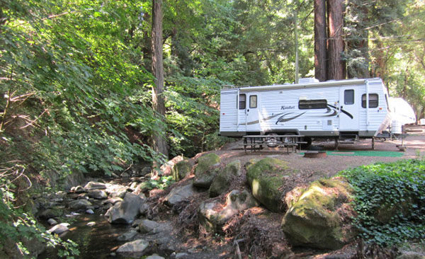 RV camping near a stream.