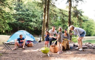 A family camping in the woods near a lake